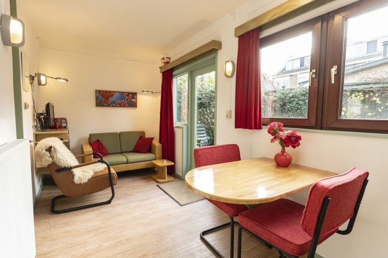 Cozy living room in Schanulleke, De Koog, Texel, vacation home with comfortable seating and dining area.