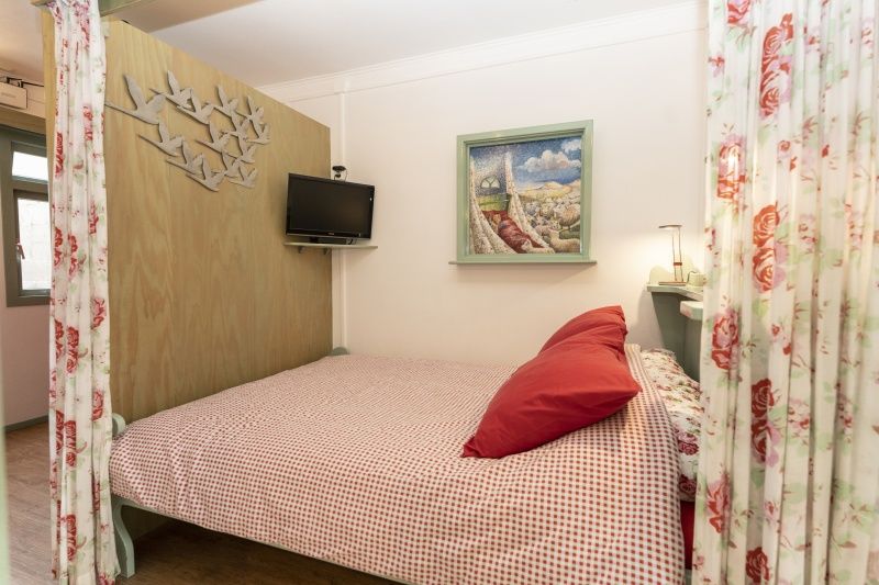 Attractive bedroom in Schanulleke, De Koog, Texel, vacation home with double bed and decorative elements.