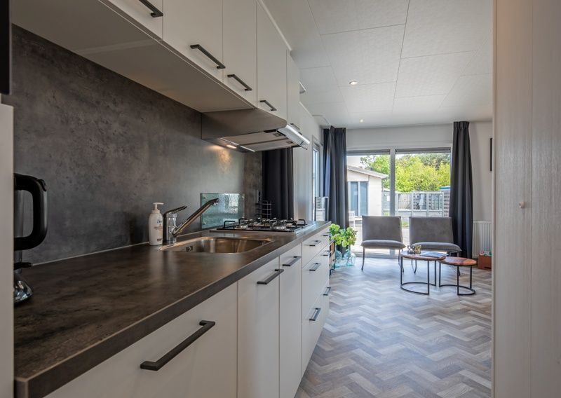 Bedroom at Chaletpark Bregkoog - Chalet Bregkoog 162, Texel with comfortable beds and restful furnishings.