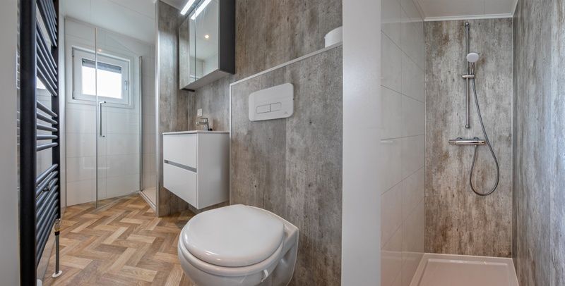 Chalet Bregkoog 162, De Koog, Texel offers a luxurious bathroom with stylish shower and contemporary furnishings.