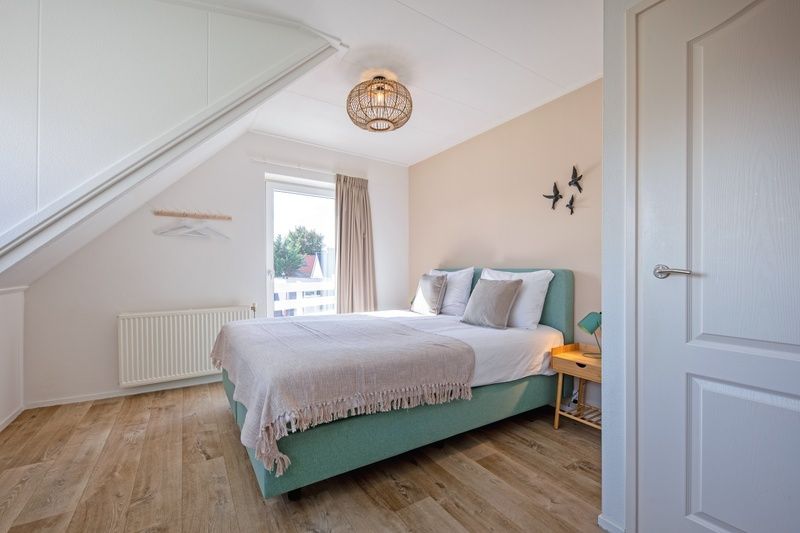 Bright bedroom with comfortable bed in Vogelweelde, vacation accommodation De Koog Texel.