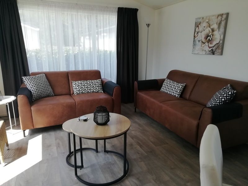 Cozy living room of Chalet Bregkoog 47 'De Muy' in De Koog, Texel. Comfortable seating area for relaxing evenings.