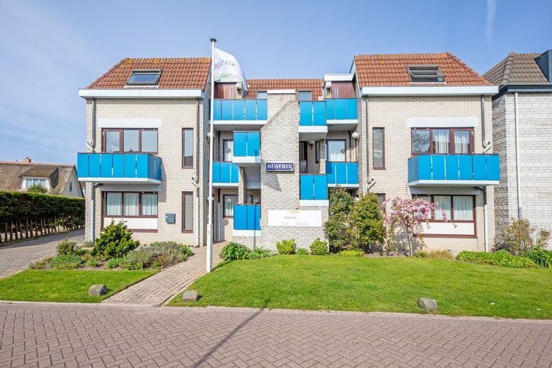 Exterior of Two persons apartment large - second floor, De Koog, Texel with balcony and green surroundings.