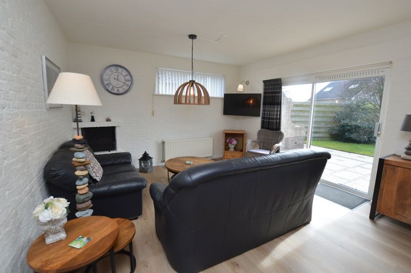 Cozy living room in Holiday home Stappeland 205, De Koog, Texel with comfortable seating area and access to the garden.