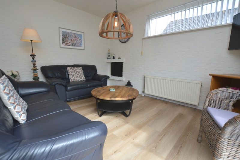 Intimate sitting area in Holiday Home Stappeland 205, De Koog, Texel with comfortable sofas and cozy furnishings.