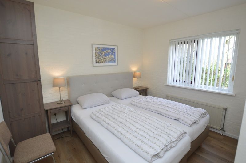 Comfortable bedroom in Holiday home Stappeland 205, De Koog, Texel with a large bed and peaceful ambiance.