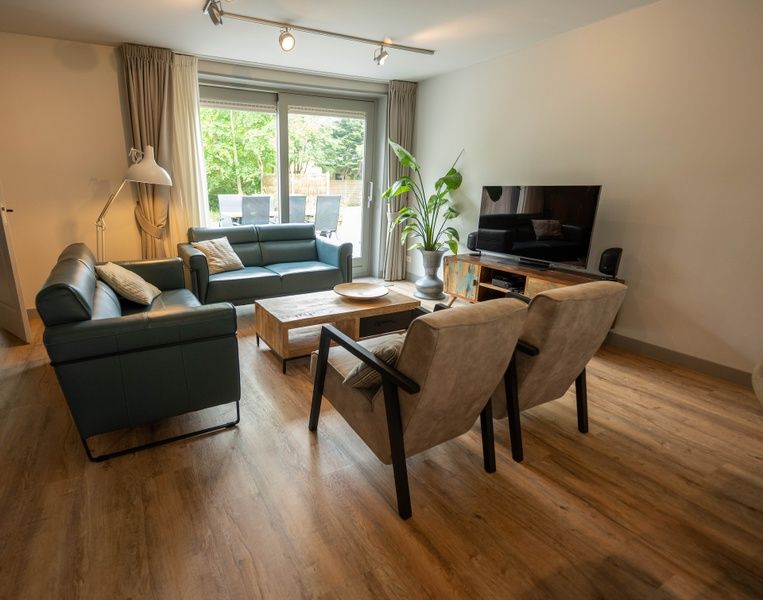 Comfortable sitting area in Landgoed Springtij - Stulpje in De Koog Texel overlooking terrace.