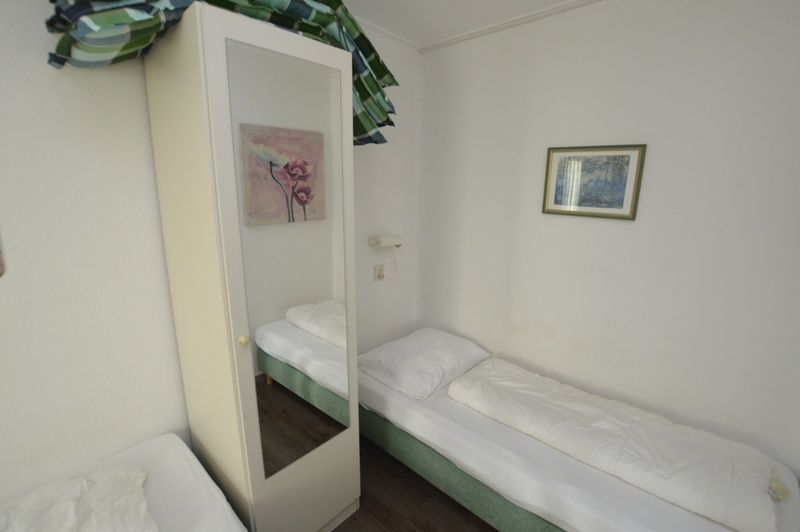 Cozy bedroom in Motel Texel - Apartment 315/1T, De Koog, Texel with a single bed and views of the island.