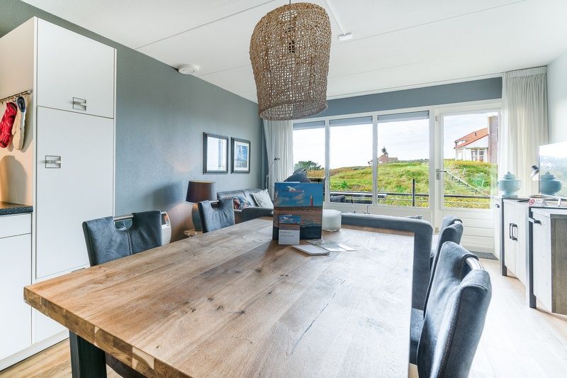 Dining area overlooking nature in Apartment Juliana 042, De Koog, Texel, perfect for family dinners.