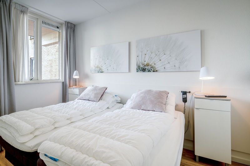 Bright bedroom in Apartment Juliana 042, De Koog, Texel, with comfortable beds and restful atmosphere.