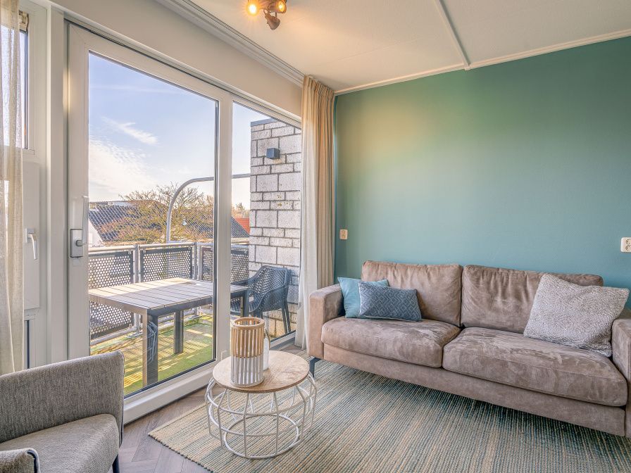 Cozy living room overlooking terrace in Apartment Zeedistel 24, De Koog, Texel.