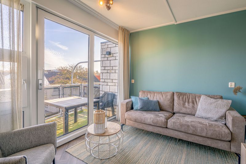 Bright living room with comfortable sofa in Apartment Zeedistel 24, De Koog, Texel.