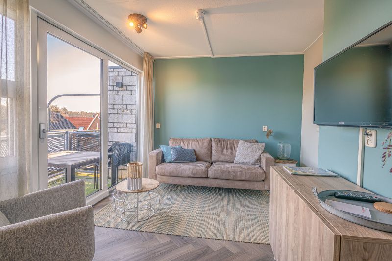 Cozy sitting area with terrace view in Apartment Zeedistel 24, De Koog, Texel.
