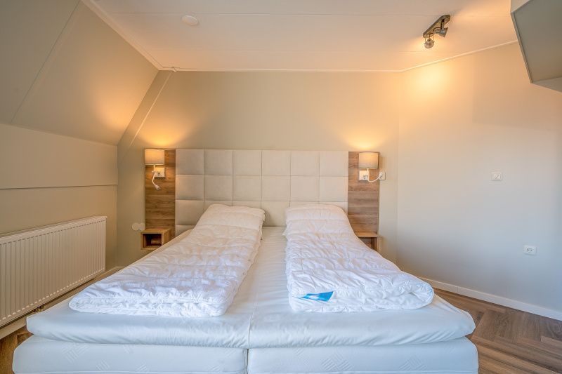 Comfortable double bed in bedroom of Apartment Zeedistel 24, De Koog, Texel.
