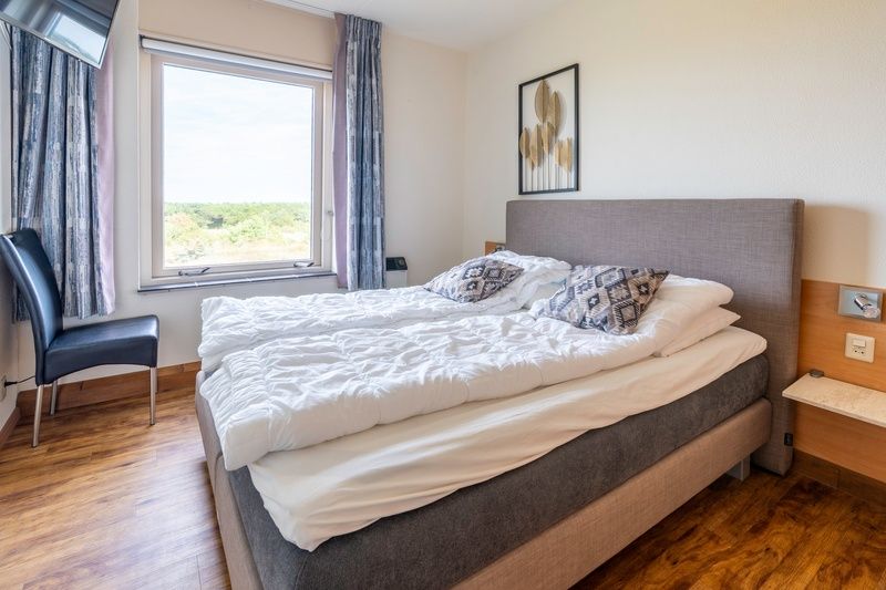 Bedroom in Apartment Juliana 168 Zeezicht, De Koog Texel, with comfortable bed and nature view.