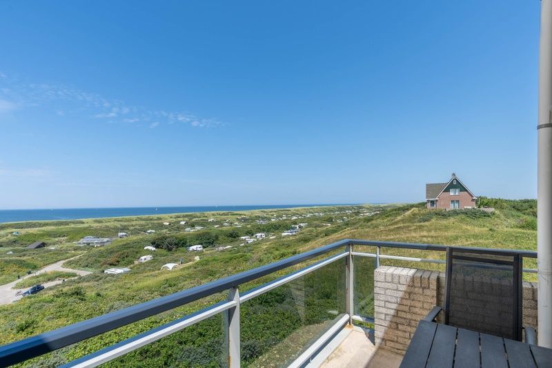 Balcony of Apartment Juliana 168 Zeezicht, De Koog Texel, with breathtaking views of sea and nature.