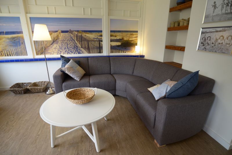 Comfortable sitting area in Grand Hotel Opduin - Holiday home C, De Koog, Texel, with attractive decorations and beach picture.