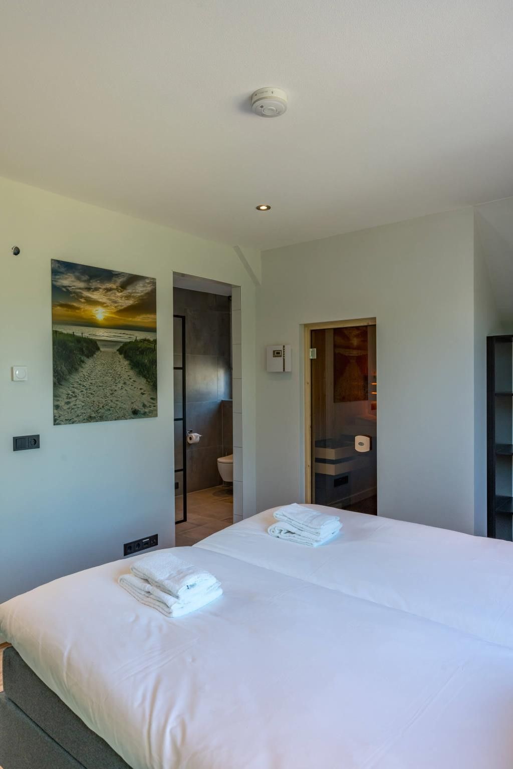 Spacious bedroom with art in Kluut 16a vacation home in De Koog, Texel.