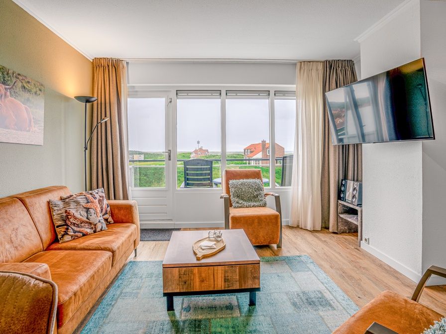Cozy living room in Apartment Juliana 136 Island and Sea View, De Koog, Texel with a view of nature.