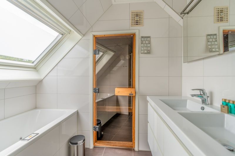 Luxury bathroom with sauna in Holiday home Kamperfoelie 69, De Koog, Texel, for ultimate relaxation.