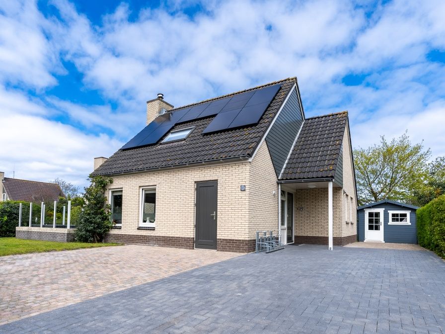 Vacation home Honeysuckle 87 in De Koog Texel with sunny exterior facade and driveway.