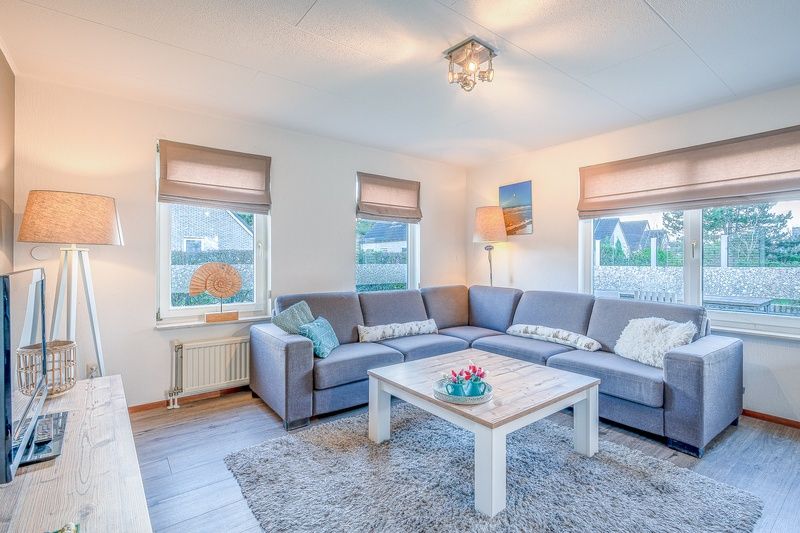 Cozy living room of Holiday home Kamperfoelie 87 in De Koog Texel with comfortable seating area.