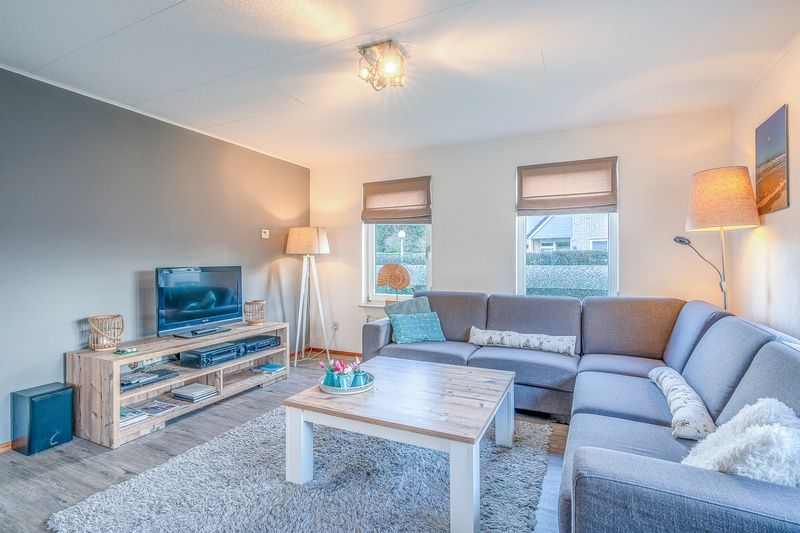 Modern living room with TV in Holiday home Honeysuckle 87, De Koog Texel, ideal for relaxation.