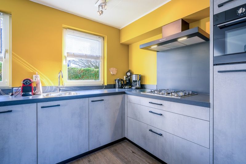 Modern kitchen in Holiday home Honeysuckle 87, De Koog Texel with sleek decor.