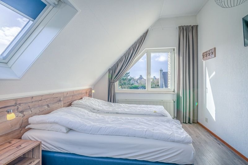 Bedroom in Holiday home Kamperfoelie 87, De Koog Texel with comfortable double bed and view.