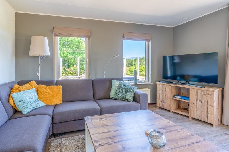 Vacation home Honeysuckle 71 in De Koog, Texel with spacious seating area and flat-screen TV.