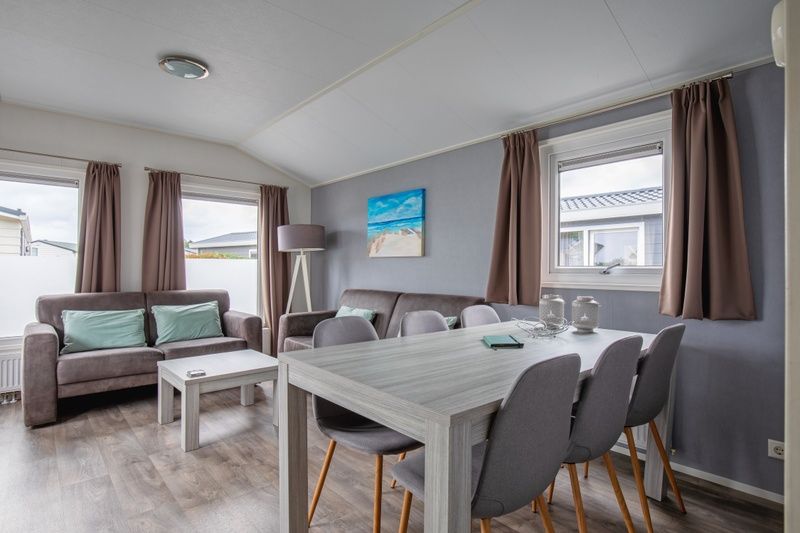 Dining area in Chalet Bregkoog 7, De Koog, Texel with modern decor and lots of natural light.