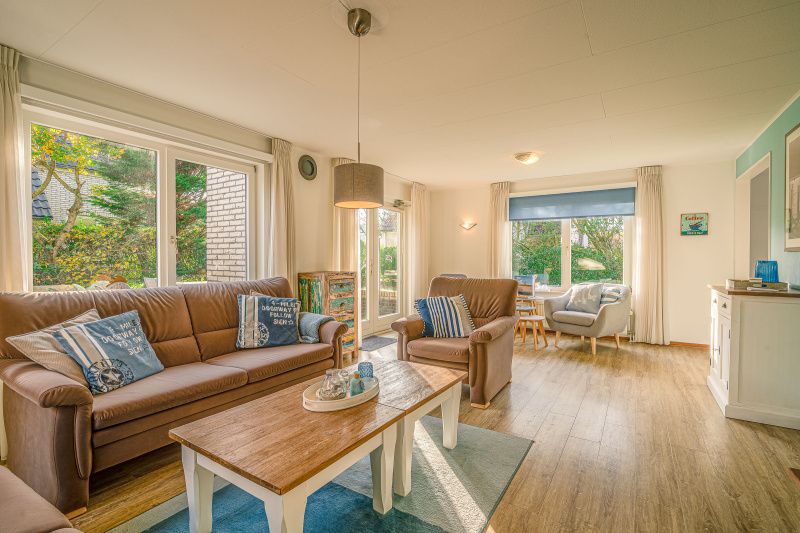 Stylish living room of Holiday home Honeysuckle 65 in De Koog, Texel, overlooking the garden.