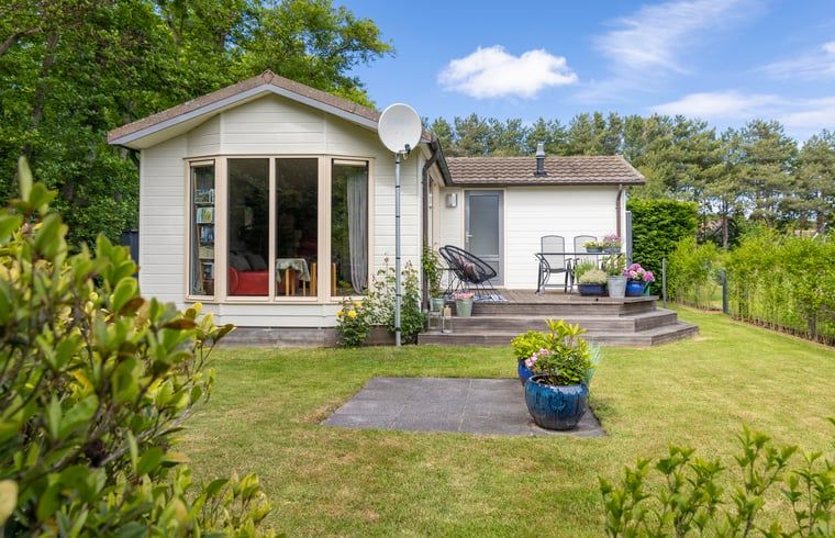 Vacation cottage in De Koog with inviting veranda and flowering garden, Texel, Wadden Islands.