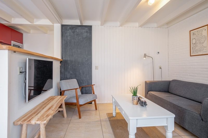 Stylish sitting area in vacation home 32b Pollux, De Koog, Texel with wooden elements.