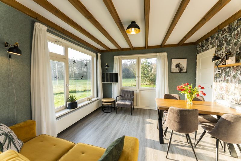 Cozy living room of De Koperwiek in De Koog Texel overlooking the garden.