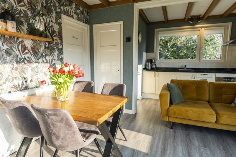 Stylish dining and sitting area in De Koperwiek vacation home De Koog Texel.