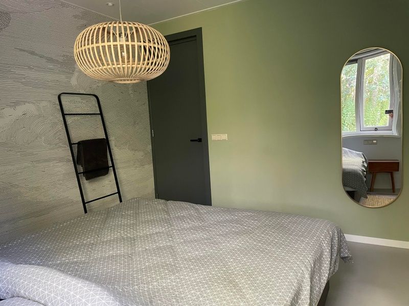 Attractive bedroom in De Koerie vacation home De Koog Texel with stylish decoration and natural light.