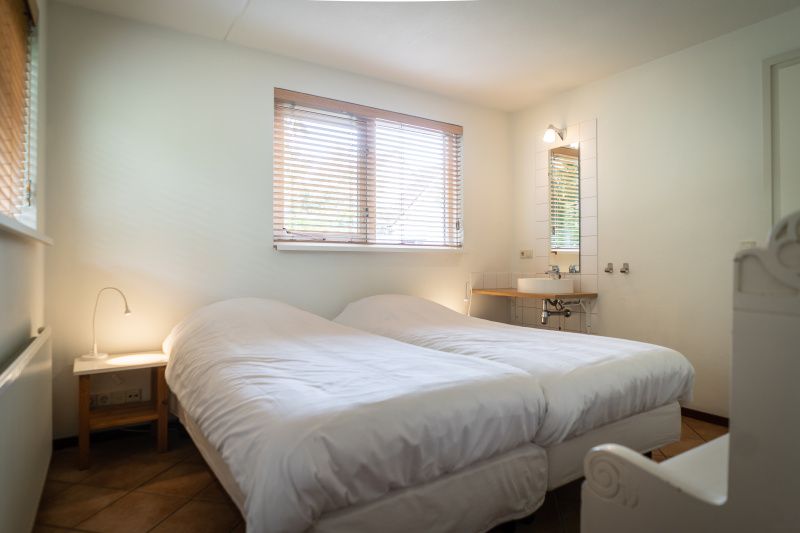 Bedroom with two beds in Villa 6 persons with 2 bathrooms, De Koog, Texel. Comfortable vacation home on the Wadden Islands.