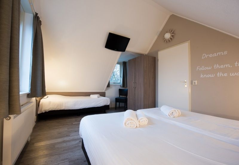 Cozy bedroom with wooden floor in Villa 7 vacation home in De Koog Texel.