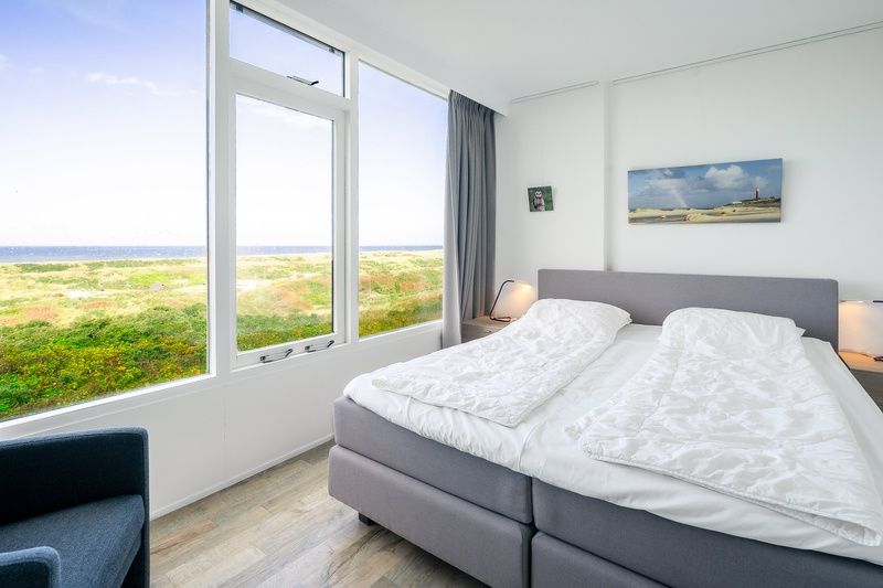 Bedroom of Apartment Juliana 112 Zeezicht in De Koog, Texel overlooking the dunes and sea.