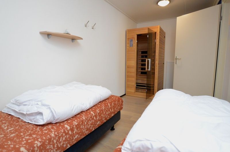 Bedroom with sauna in Apartments Anna - Sun, De Koog, Texel, for ultimate relaxation during your stay.