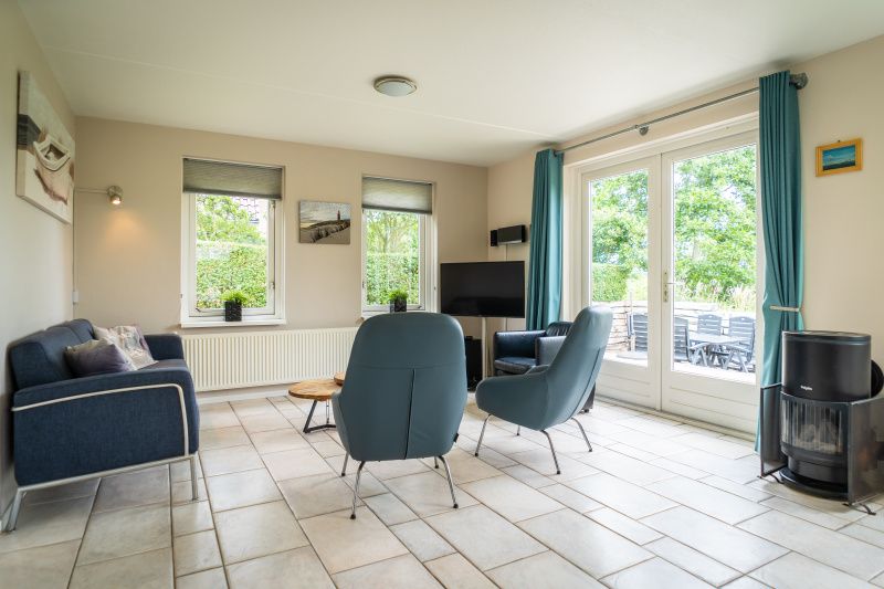 Cozy interior of Villa 6 persons, De Koog, Texel. Modern decor and terrace access in this vacation home in the Wadden Islands.