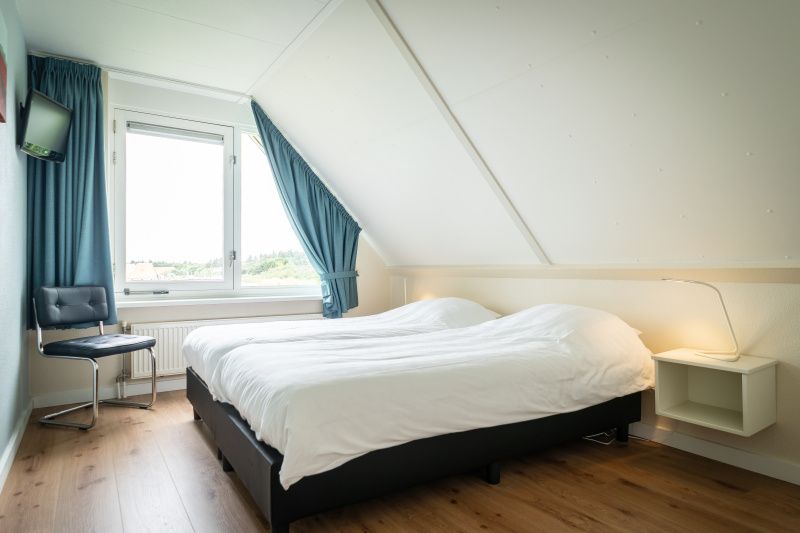 Comfortable bedroom in Villa 6 persons, De Koog, Texel. Cozy atmosphere and views of Texel from this vacation home on the Wadden Islands.