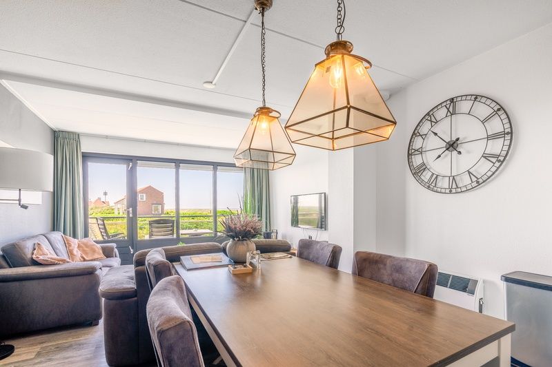 Dining room in Apartment Juliana 094 Island and Sea View, De Koog, Texel overlooking the green surroundings.