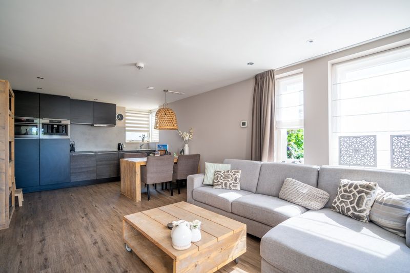 Open kitchen and living room in Apartment Juliana 034 Eilandzicht, De Koog, Texel with lots of natural light.