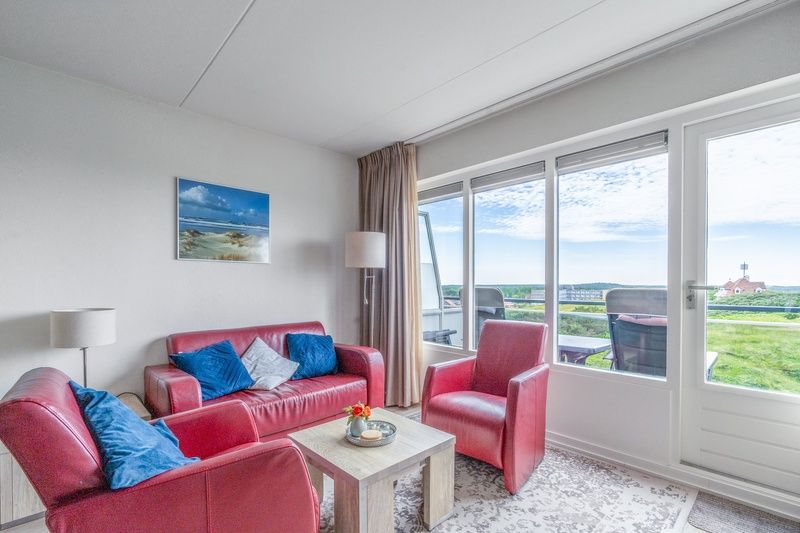 Comfortable sitting area in Apartment Juliana 138, De Koog, Texel, overlooking nature.