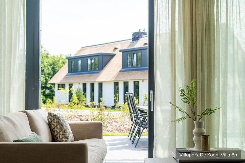 Interior Luxury family villa 8p in De Koog, Texel with cozy living room and views of nature.