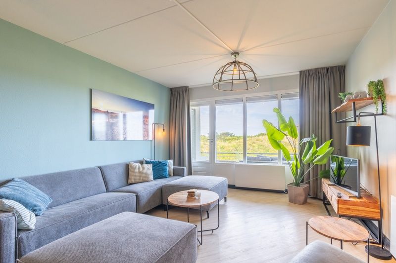 Moderne Sitzecke im Appartement Juliana 044 Insel- und Meerblick, De Koog, Texel mit bequemem Sofa.