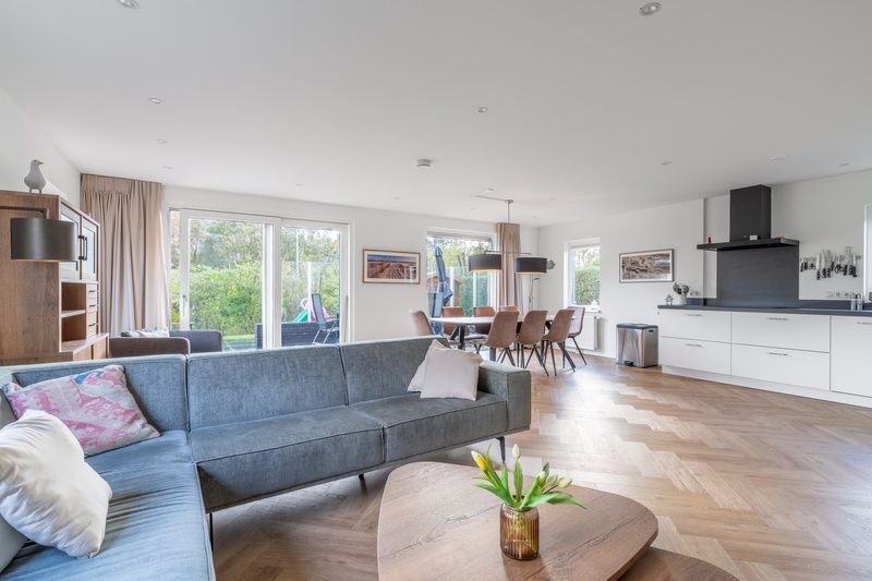 Dining area and living room in Stappeland 197, vacation home De Koog, Texel with lots of natural light.