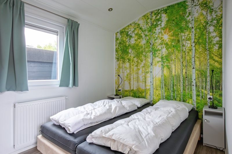 Attractive bedroom in Chalet Bregkoog 12, De Koog, Texel with a soothing forest theme on the Wadden Islands.